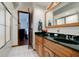 Bathroom with double vanity, dark countertop, and a walk-in shower at 6605 Donnelly Dr, Brownsburg, IN 46112