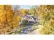 Two-story house nestled in a wooded area with fall foliage at 6902 Creekridge Trl, Indianapolis, IN 46256