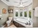 Spa-like bathroom with soaking tub, walk-in shower, and bay window at 6902 Creekridge Trl, Indianapolis, IN 46256