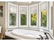 Relaxing bathroom with soaking tub and large window at 6902 Creekridge Trl, Indianapolis, IN 46256