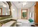 Updated bathroom with a bathtub and decorative mirror at 6902 Creekridge Trl, Indianapolis, IN 46256