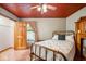 Cozy bedroom with brass bed frame and terracotta tile floor at 6902 Creekridge Trl, Indianapolis, IN 46256