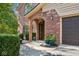 Brick front entryway with arched entry and landscaping at 6902 Creekridge Trl, Indianapolis, IN 46256