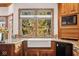 Kitchen with farmhouse sink and view of the backyard at 6902 Creekridge Trl, Indianapolis, IN 46256
