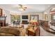 Elegant living room with a fireplace, comfortable seating, and access to the kitchen at 6902 Creekridge Trl, Indianapolis, IN 46256