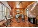 Home bar with brick wall, wood cabinetry, and tile flooring at 6902 Creekridge Trl, Indianapolis, IN 46256