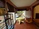 Sunroom with tiled floor, featuring a round table and large windows at 8353 N Sr 109, Wilkinson, IN 46186