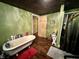 Bathroom with clawfoot tub, wood floors, and a walk-in shower at 8353 N Sr 109, Wilkinson, IN 46186