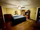 Main bedroom with king-size bed, dark wood floors, and ceiling fan at 8353 N Sr 109, Wilkinson, IN 46186