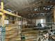 Spacious barn stalls with a tractor and hay at 8353 N Sr 109, Wilkinson, IN 46186