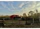 Red barn sits in the pasture with a gate at 8353 N Sr 109, Wilkinson, IN 46186