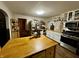 L-shaped kitchen with an island, stainless steel appliances, and wood flooring at 8353 N Sr 109, Wilkinson, IN 46186