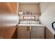 Clean laundry room with washer, dryer, and shelving at 3784 Mansfield Dr, Brownsburg, IN 46112