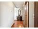 Bright hallway with hardwood floors, a wooden cabinet, and mirror at 3784 Mansfield Dr, Brownsburg, IN 46112