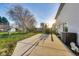 Sun-drenched backyard with patio, basketball hoop, and lush grass at 534 Austrian Way, Avon, IN 46123