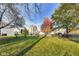 Backyard with mature trees, lush grass, and a partially visible home at 534 Austrian Way, Avon, IN 46123
