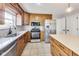 Modern kitchen with wood cabinets, stainless steel appliances, and an island at 534 Austrian Way, Avon, IN 46123
