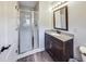 Bathroom with walk-in shower and dark vanity at 534 Austrian Way, Avon, IN 46123