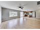 Living room with wood floors, ceiling fan and view into kitchen at 534 Austrian Way, Avon, IN 46123