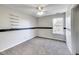 Bright bedroom with gray carpet, ceiling fan, and window at 534 Austrian Way, Avon, IN 46123