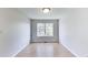 Bright bedroom with light gray walls, wood floors, and a large window at 534 Austrian Way, Avon, IN 46123