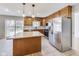Modern kitchen with wood cabinets, stainless steel appliances, and an island at 534 Austrian Way, Avon, IN 46123