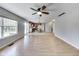 Living room with wood floors, ceiling fan and view of kitchen at 534 Austrian Way, Avon, IN 46123