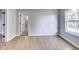 Light gray walls, wood floors, and a window overlooking the backyard at 534 Austrian Way, Avon, IN 46123