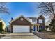 Two-story brick home with a two-car garage and blue door at 534 Austrian Way, Avon, IN 46123