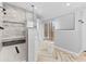 Modern bathroom with walk-in shower, herringbone tile floor, and access to a deck at 5911 N 400 W, Bargersville, IN 46106