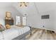 Cozy bedroom with vaulted ceilings, a comfortable bed, and access to the bathroom at 5911 N 400 W, Bargersville, IN 46106