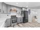 Updated kitchen featuring gray cabinets, stainless steel range, and wood flooring at 5911 N 400 W, Bargersville, IN 46106