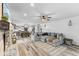 Open living room with a sectional sofa, fireplace, and view into the kitchen at 5911 N 400 W, Bargersville, IN 46106
