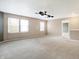 Spacious bonus room with neutral carpeting and ceiling fan at 6938 Merritt Ridge Way, Avon, IN 46123