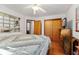 Bright bedroom with hardwood floors, ceiling fan, and large closet at 827 S Brentwood Ave, Indianapolis, IN 46239