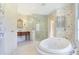 Elegant bathroom with soaking tub, walk-in shower, and marble floors at 2505 Riverside Dr, Columbus, IN 47201