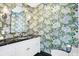 Charming bathroom with floral wallpaper and dark vanity at 2505 Riverside Dr, Columbus, IN 47201