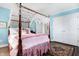 Bedroom with canopy bed, area rug and double doors to closet at 2505 Riverside Dr, Columbus, IN 47201