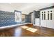 Spacious bedroom with hardwood floors, floral wallpaper, and built-in storage at 2505 Riverside Dr, Columbus, IN 47201