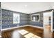 Spacious bedroom with hardwood floors and decorative wallpaper at 2505 Riverside Dr, Columbus, IN 47201