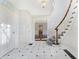 Grand entryway with curved staircase and marble flooring at 2505 Riverside Dr, Columbus, IN 47201