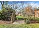 Charming garden path with arch and manicured landscaping leading to the house at 2505 Riverside Dr, Columbus, IN 47201