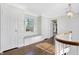 Charming hallway with hardwood floors, window seat, and decorative wallpaper at 2505 Riverside Dr, Columbus, IN 47201