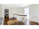 Elegant hallway with hardwood floors, curved staircase, and decorative wallpaper at 2505 Riverside Dr, Columbus, IN 47201