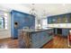 Spacious kitchen with large island, blue cabinetry, and granite countertops at 2505 Riverside Dr, Columbus, IN 47201