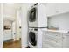 Upper-level laundry room with stacked washer and dryer, and ample cabinet space at 2505 Riverside Dr, Columbus, IN 47201