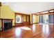 Sunlit living room with hardwood floors, fireplace, and built-in shelving at 2505 Riverside Dr, Columbus, IN 47201