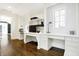 Home office with built-in desks, shelving, and hardwood floors at 2505 Riverside Dr, Columbus, IN 47201