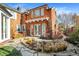 Stone patio with pond, lush landscaping, and French doors leading inside at 2505 Riverside Dr, Columbus, IN 47201