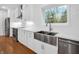 White kitchen with stainless steel farm sink and herringbone backsplash at 1456 Northern Valley Trail, Avon, IN 46123